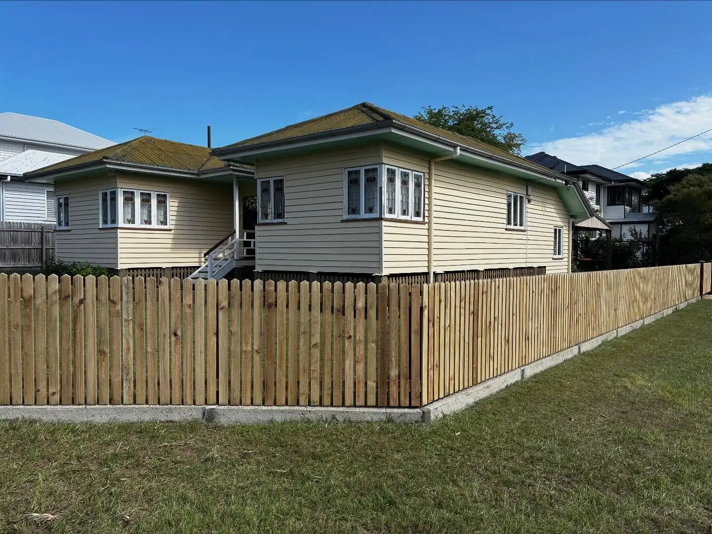 Timber picket fence wrapping a classic Queenslander cottage